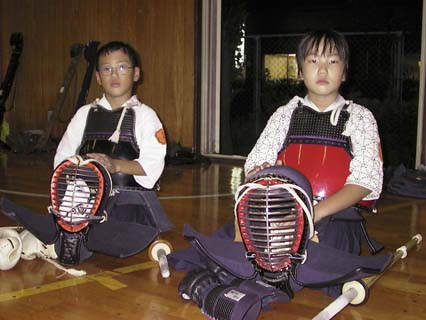 A pair of young people taking a break. kendo break